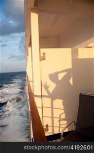 Shadow of a person gesturing on a cruise ship Silver Shadow, East China Sea