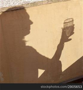Shadow of a person holding a wine glass, Stockholm, Sweden