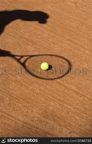 Shadow of a tennis racket on a tennis ball