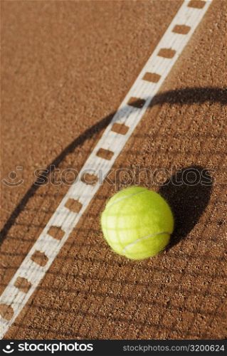 Shadow of a tennis racket over a tennis ball