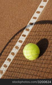 Shadow of a tennis racket over a tennis ball