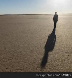 Shadow of a woman on Erg Chegaga Dunes in Sahara Desert, Guelmim-Es Semara, Morocco
