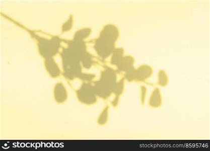 Shadow of leaves on the wall, summer relax background in ywloow color. Shadow of leaves on the wall