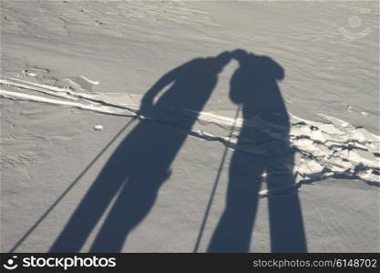 Shadow of skiers in snow, Emerald Lake,Field, British Columbia, Canada