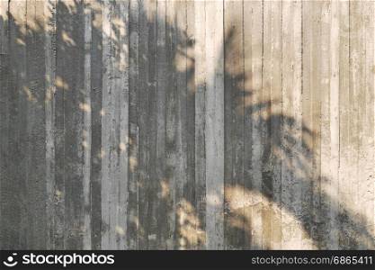 shadow of tree on raw concrete wall with wooden form work texture