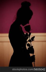 Shadow of woman holding a flower