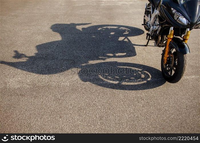 shadow orange motorbike asphalt