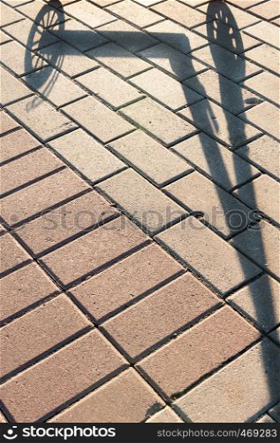 shadow scooter on the stone walkway