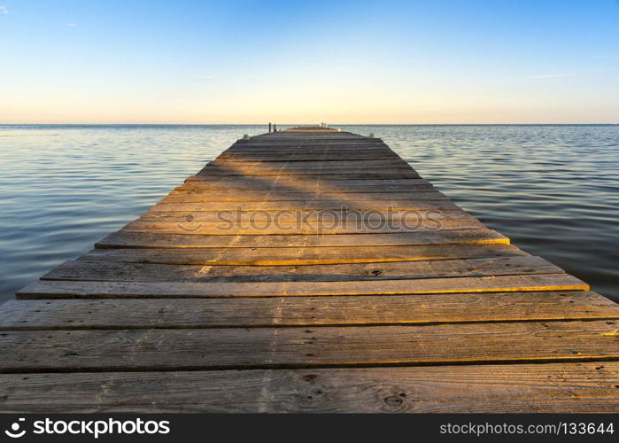 Shadows On Jetty. Shadows cut across wooden jetty at sunset