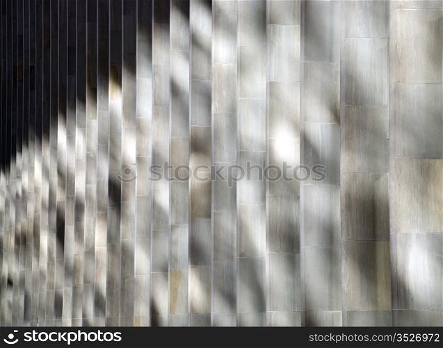 Shadows. Vertical shadow pattern on the exterior wall of the building .