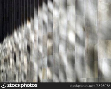 Shadows. Vertical shadow pattern on the exterior wall of the building .