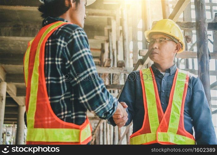 Shake hand concept, two engineer shake hand on site construction to success project