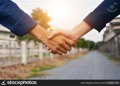 Shake hands Success project trust concept sunlight background