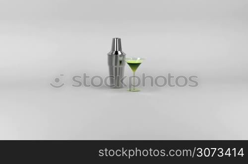 Shaker and cocktail glass with green colored drink, zoom to the drinks