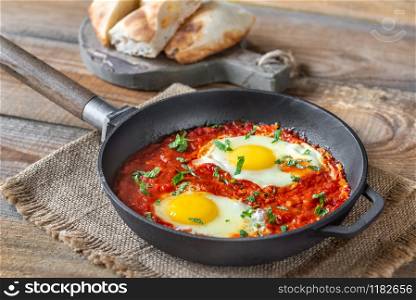Shakshouka - eggs poached in tomato sauce, served in a frying pan