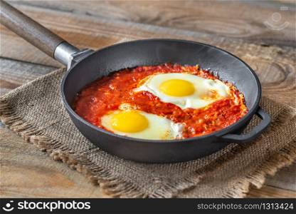 Shakshouka - eggs poached in tomato sauce, served in frying a pan