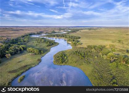 shallow and wide Dismal River meandering trough Nebraska Sandhills at Nebraska National Forest, aerial view of late summer or early fall scenery