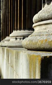 Shallow depth of field on line of stone pillars, concept of strength, justice and integrity