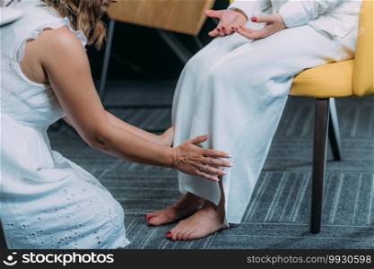 Shamballa Therapist Holding Hands Over Legs of the Female Client. Shamballa Enlightenment Therapy