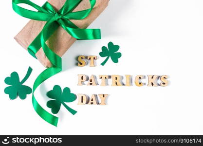 Shamrock and gift with green ribbon on white background. Good luck symbols for St. Patrick’s Day. Irish holiday.. Shamrock and gift with green ribbon on a white background. Good luck symbols for St. Patrick’s Day. Irish holiday.