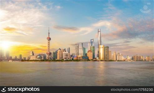 Shanghai city skyline Pudong side looking through Huangpu river on a sunny day. Shanghai, China. Beautiful vibrant panoramic image.. Shanghai city skyline Pudong side looking through Huangpu river on a sunny day.