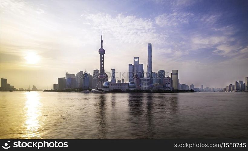 Shanghai city skyline Pudong side looking through Huangpu river on morning time. Shanghai, China. Beautiful vibrant panoramic image.