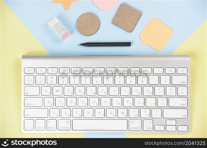 shapes eraser pencil near white keyboard dual backdrop