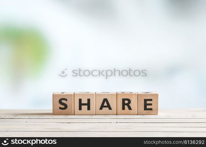 Share word made of cubes on a wooden table