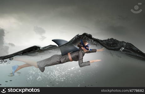 Shark of business world. Young businesswoman with shark flipper swiming under water