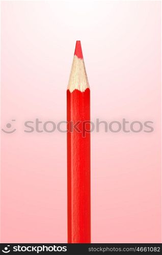 Sharp color pencil isolated on red background