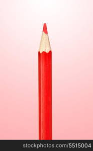 Sharp color pencil isolated on red background