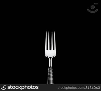 Sharp metal fork on black background