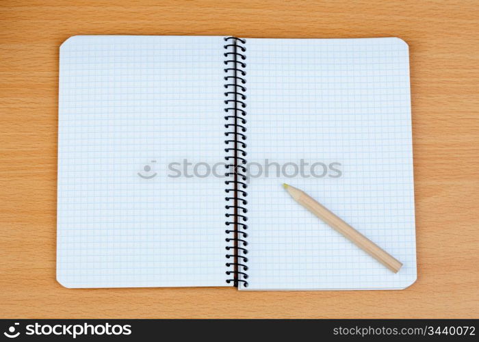 Sharp pencil on a spiral notebook in blank