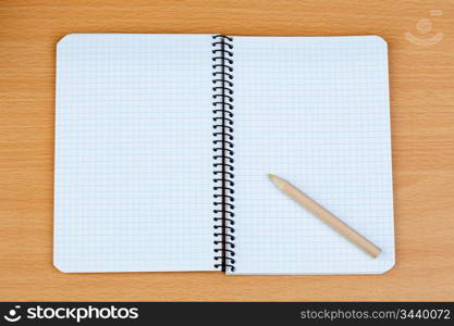 Sharp pencil on a spiral notebook in blank