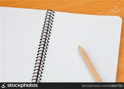 Sharp pencil on a spiral notebook in blank