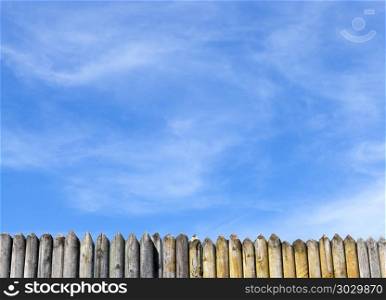 sharp stockade. a small part of the sharp stockade made of pine against the blue sky, the landscape in the spring
