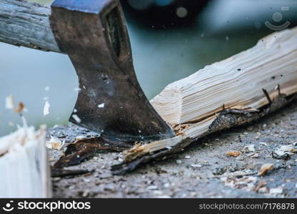 Sharpe axe is cutting wood for making fire, close up picture