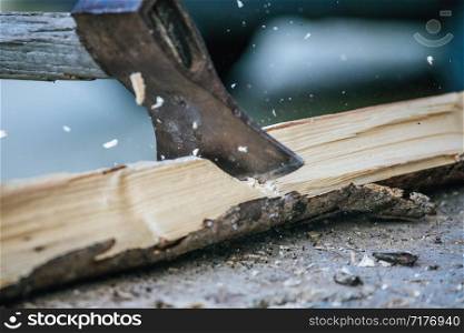 Sharpe axe is cutting wood for making fire, close up picture