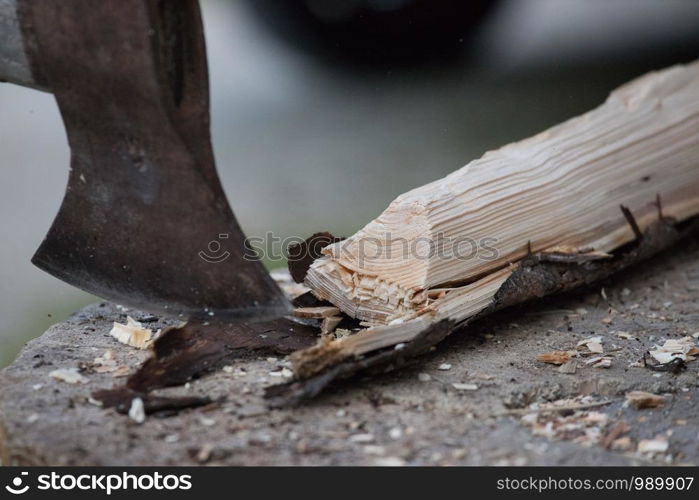 Sharpe axe is cutting wood for making fire, close up picture