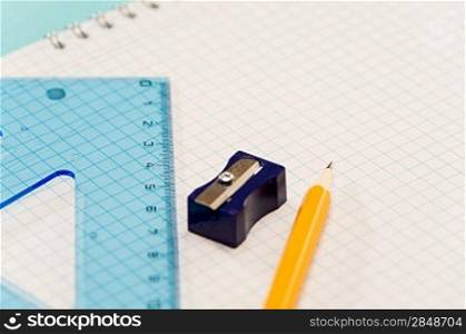 Sharpener with ruler, pencil on notepad school supplies
