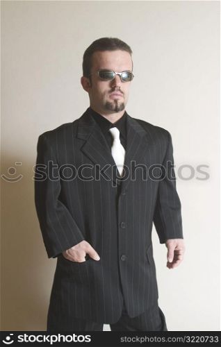 Sharply Dressed Man Posing with Sunglasses