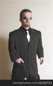 Sharply Dressed Man Posing with Sunglasses