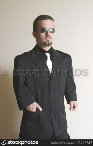 Sharply Dressed Man Posing with Sunglasses