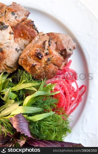 shashlik with potherbs on the plate