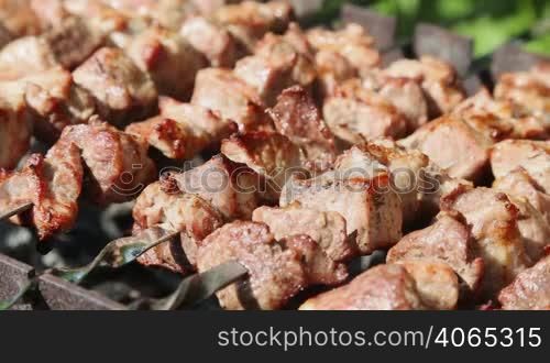 Shashlyk (kebab) grilling on the bbq, closeup view