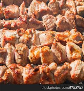 Shashlyk (kebab) grilling on the bbq, closeup view&#xA;