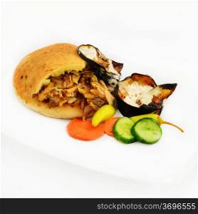 Shawarma in pita with scorched eggplant in tahinni and vegetables.