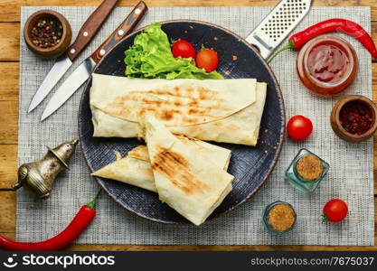 Shawarma,Middle Eastern dish made from fried chicken meat wrapped in pita bread. Shawarma sandwich on plate