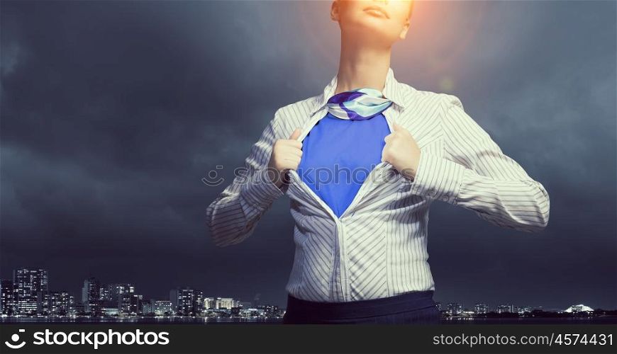 She feels powerful and brave. Businesswoman opening her shirt on chest like superhero