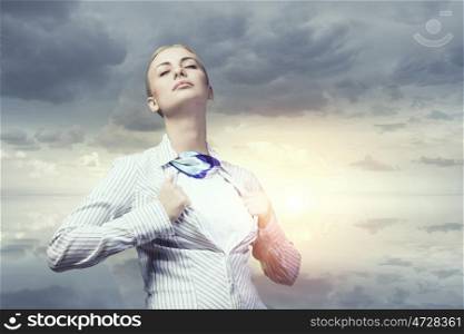 She feels powerful and brave. Businesswoman opening her shirt on chest like superhero